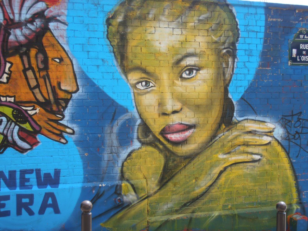 Black woman face with blue eyes.  Street art canal de l'Ourcq.  Paris - Rue de l'Oise.  Photo Credit: Jeanne MENJ (https://flic.kr/p/feg1tS) used under a Creative Common License